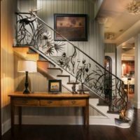 staircase design in a house with wrought iron railing