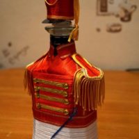 A bottle of a skate in the uniform of a hussar