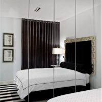 Wardrobe with mirrored doors in the design of the bedroom 12 sq m