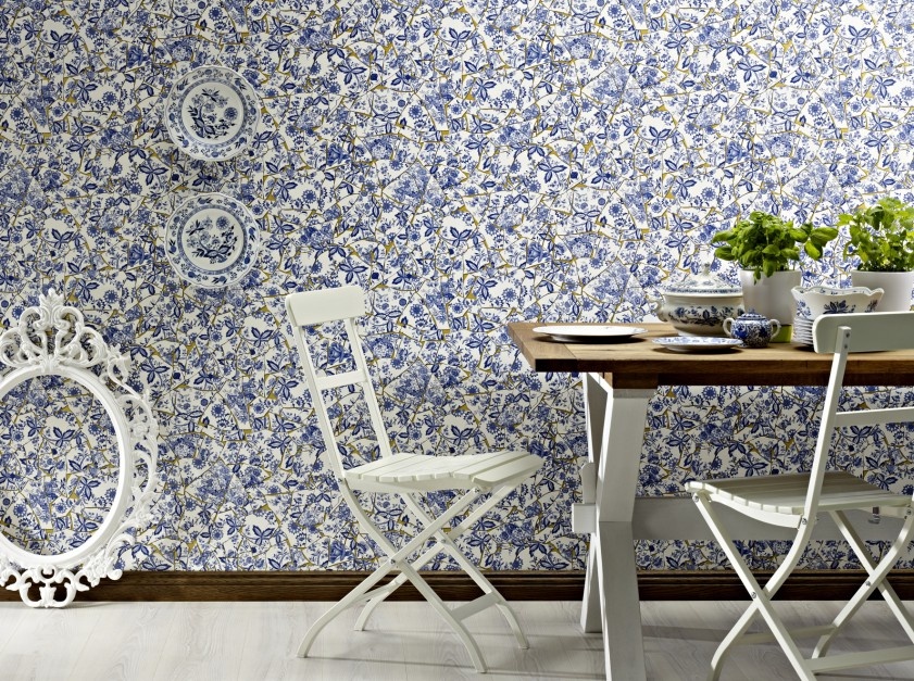 Dining table near the wall covered with paper wallpaper