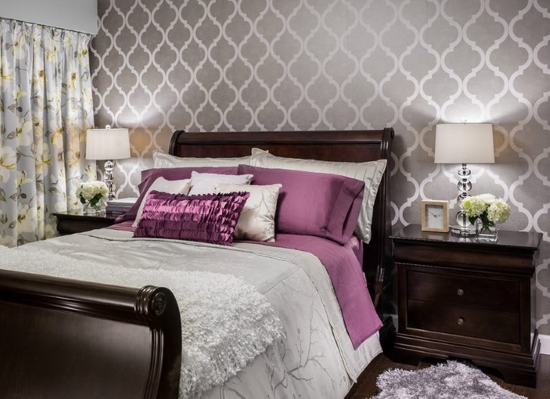 Lilac pillows in the bedroom interior with black furniture