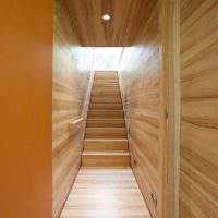 Wood trim of the narrow corridor and stairs to the second floor