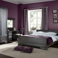 Dark lilac walls and gray bed