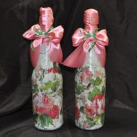 Pink ribbons on wedding bottles