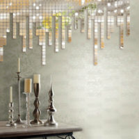 Mirror mosaic on the wall and candlesticks on the table