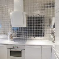 Mirror mosaic and white facades in a modern kitchen