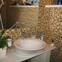 Multicolor mosaic elements on the walls around the sink