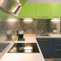 Mirror mosaic and green facades in the design of the kitchen
