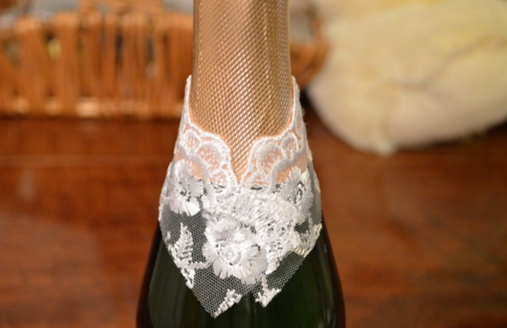 Sticker lace on the neck of a bottle of champagne for decoration under the bride