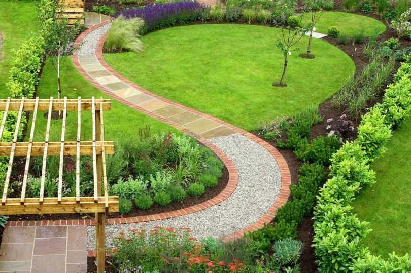 A winding garden path made from a combination of different materials