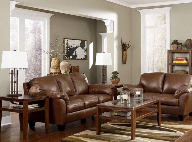 Brown faux leather sofa against light gray living room walls