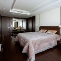 Cream bedspread in bed in brown bedroom