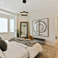 Minimalist chandelier over the bed in the spouses bedroom