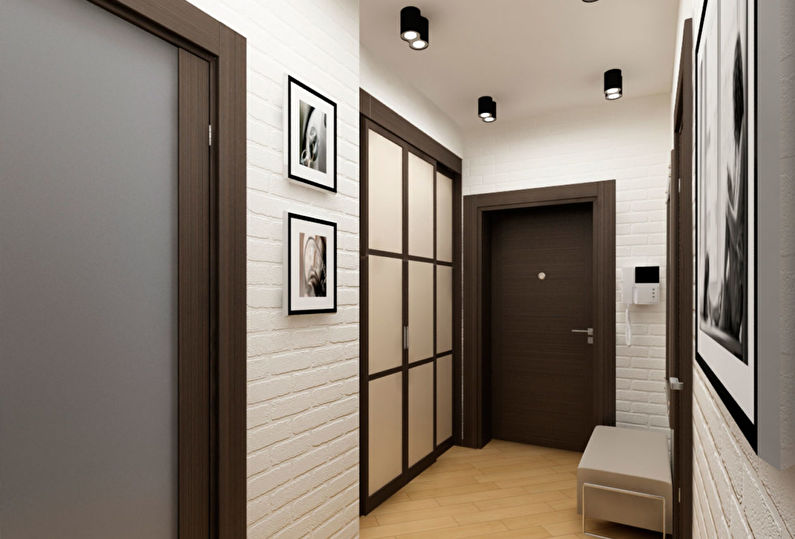 Muri di mattoni bianchi nella progettazione di un piccolo corridoio