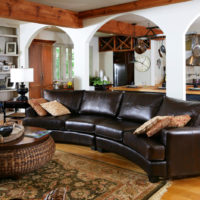 Dark brown sofa in the interior of the living room of a private house