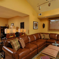 Brown sofa on the background of yellow walls