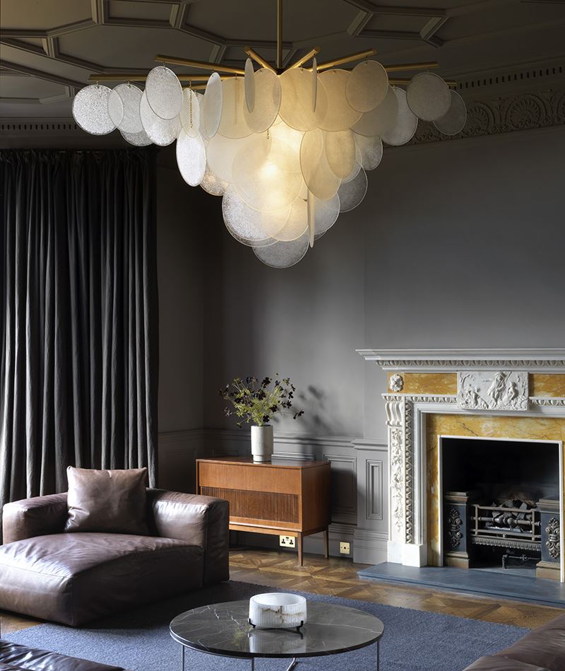 Originalni luster u obliku oblaka u sobi sa sivim interijerom