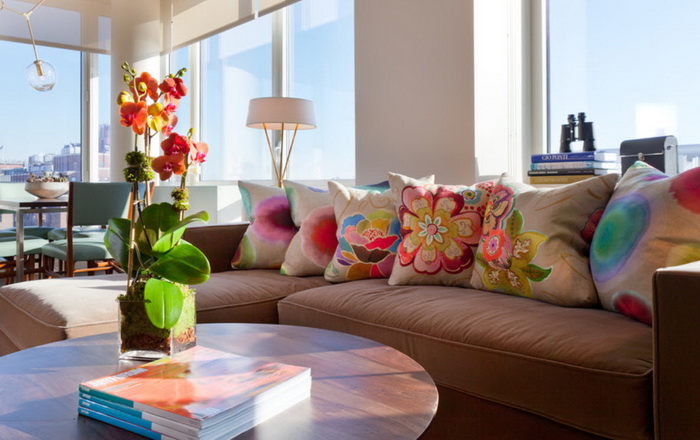 Pillows with flowers on a brown sofa