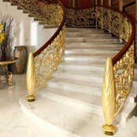Staircase with golden railing in a private house