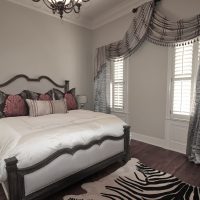 Light gray walls in the bedroom of the spouses