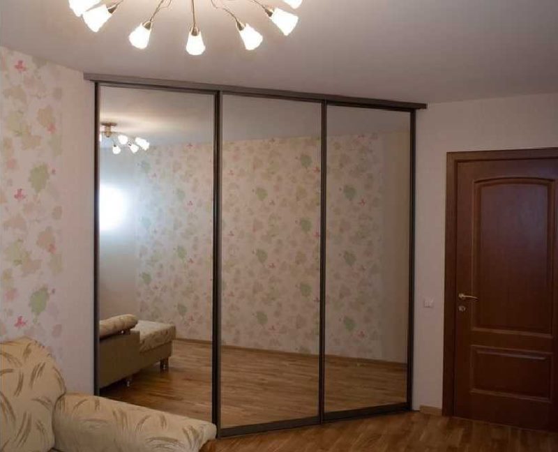 Mirrored doors of a triangular sliding wardrobe