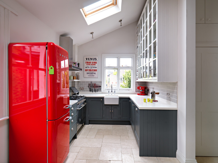 Glossy surface of the red refrigerator in retro style
