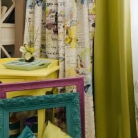Yellow table near olive curtains