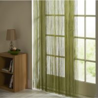 Curtains on the door made of green threads