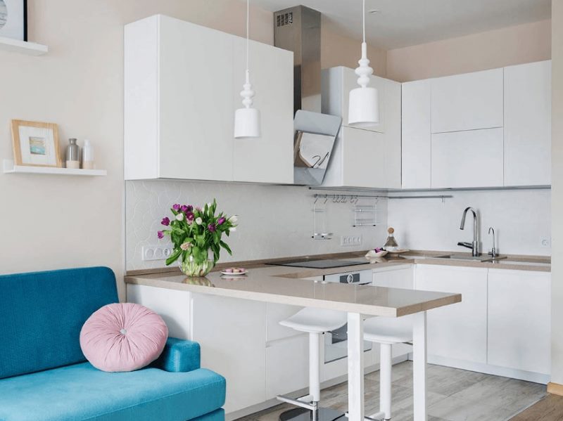 White kitchen with breakfast bar and turquoise sofa