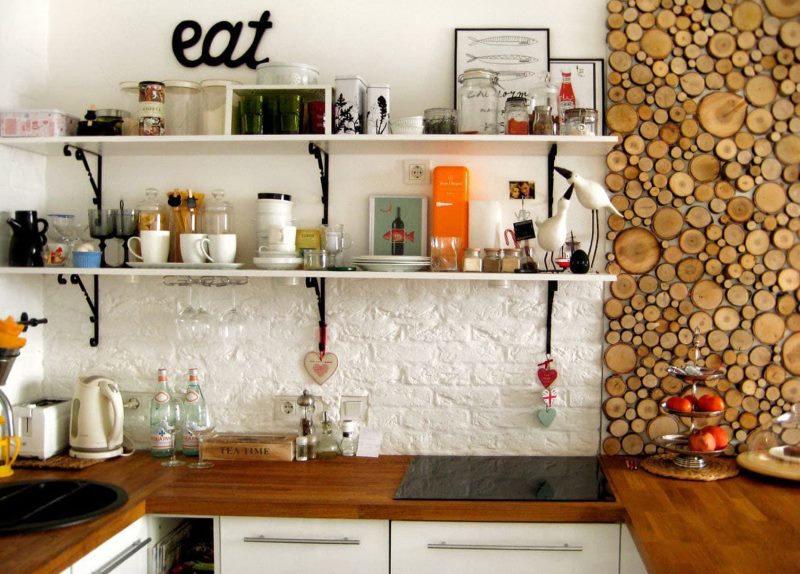 Open kitchen shelves over a white stone apron