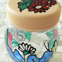 Spice jar with a flower on the lid