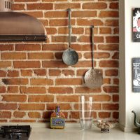 Vintage kitchen utensils on a brick wall