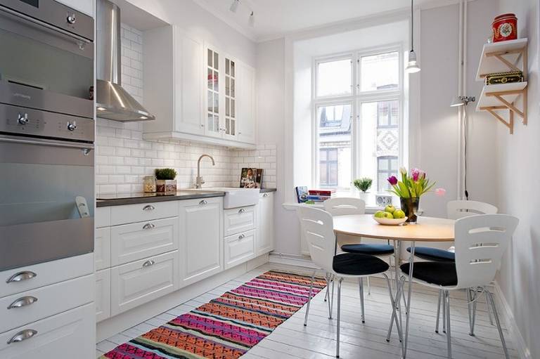 Colorful rug in the interior of a white kitchen