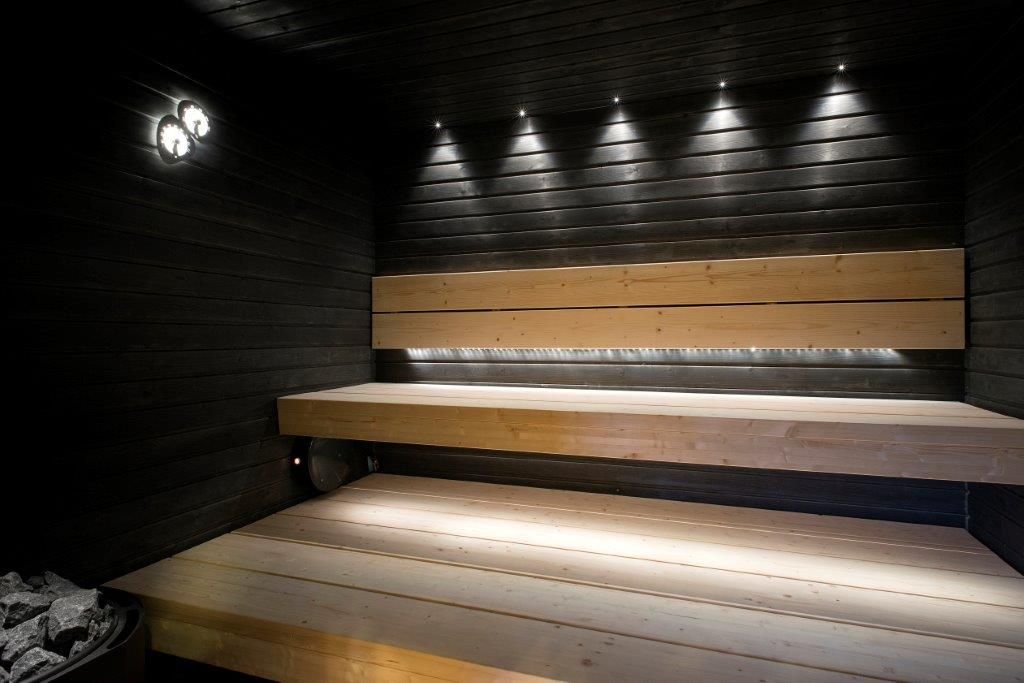 Lighting the shelves in the steam room with dark walls