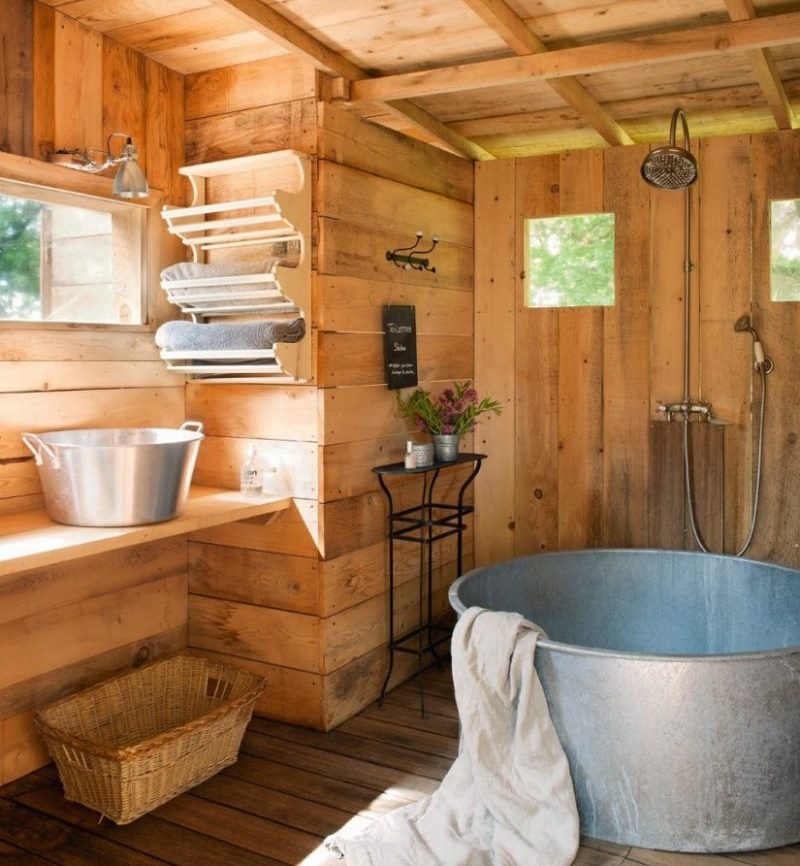 Shelf for bath towels on a wooden wall