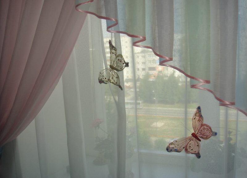 Papillons décoratifs sur les rideaux dans la chambre d'une fille