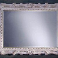 Elegante specchio in una baguette di legno