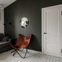 Fauteuil en bois dans une pièce aux murs gris foncé