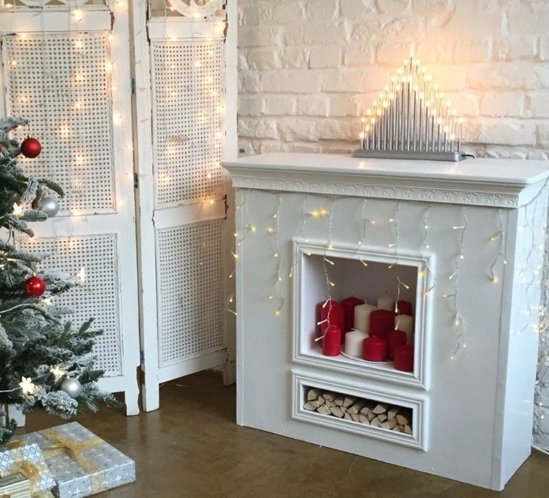 Decorative fireplace with a New Year's garland