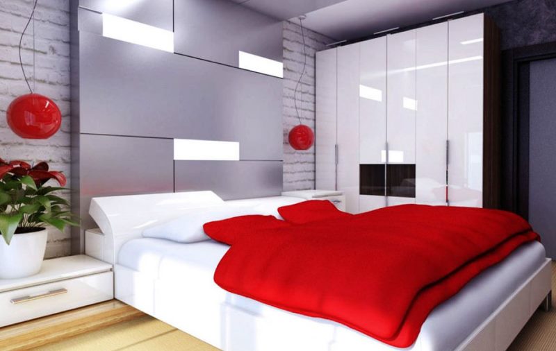 Red bedspread in a bed in a modern apartment