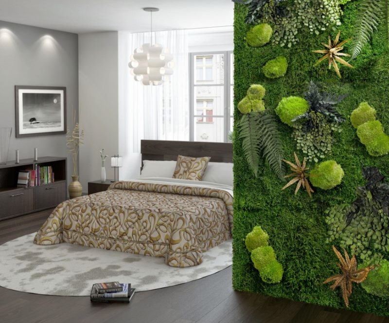Green wall of living moss in the bedroom interior