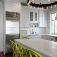Light green chairs in the kitchen of a country house